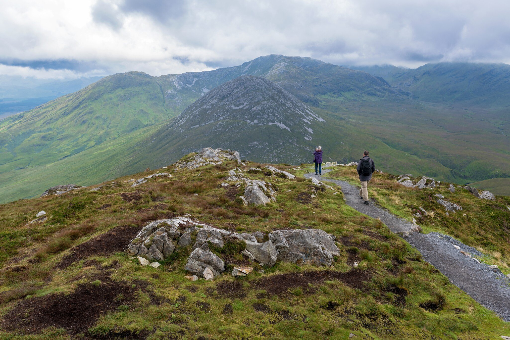 A wide shot of hikers in on a rocky mountain in Connemara, Ireland