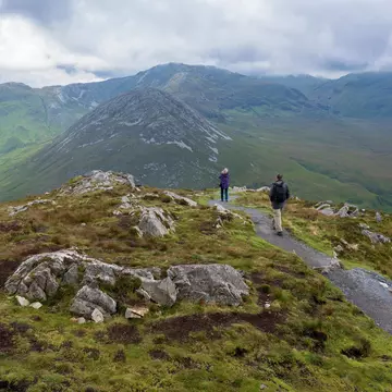 A wide shot of hikers in on a rocky mountain in Connemara, Ireland
