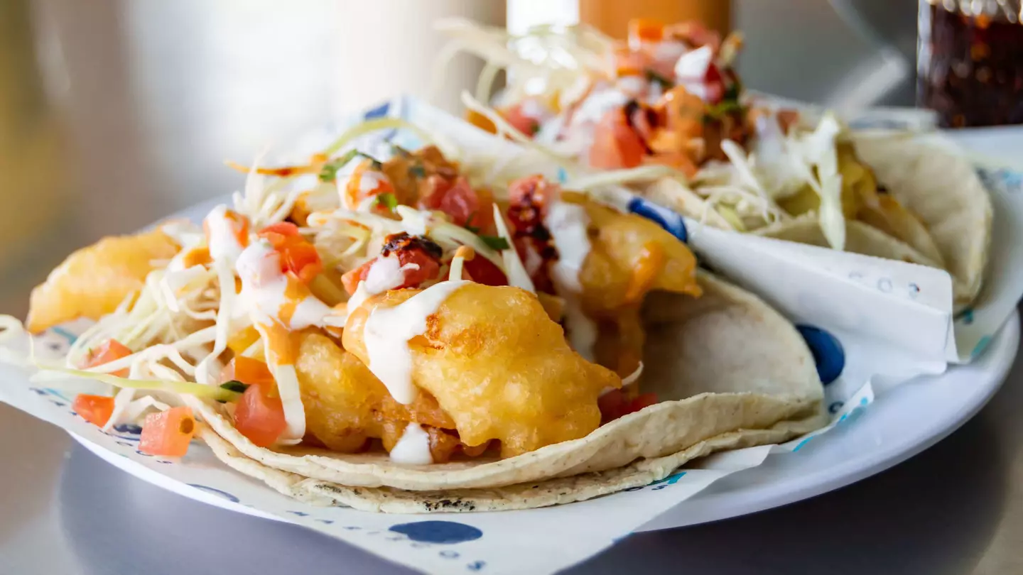 Baja California style fish and shrimp tacos, topped with cabbage, tomatoes, cilantro and a variety of salsas