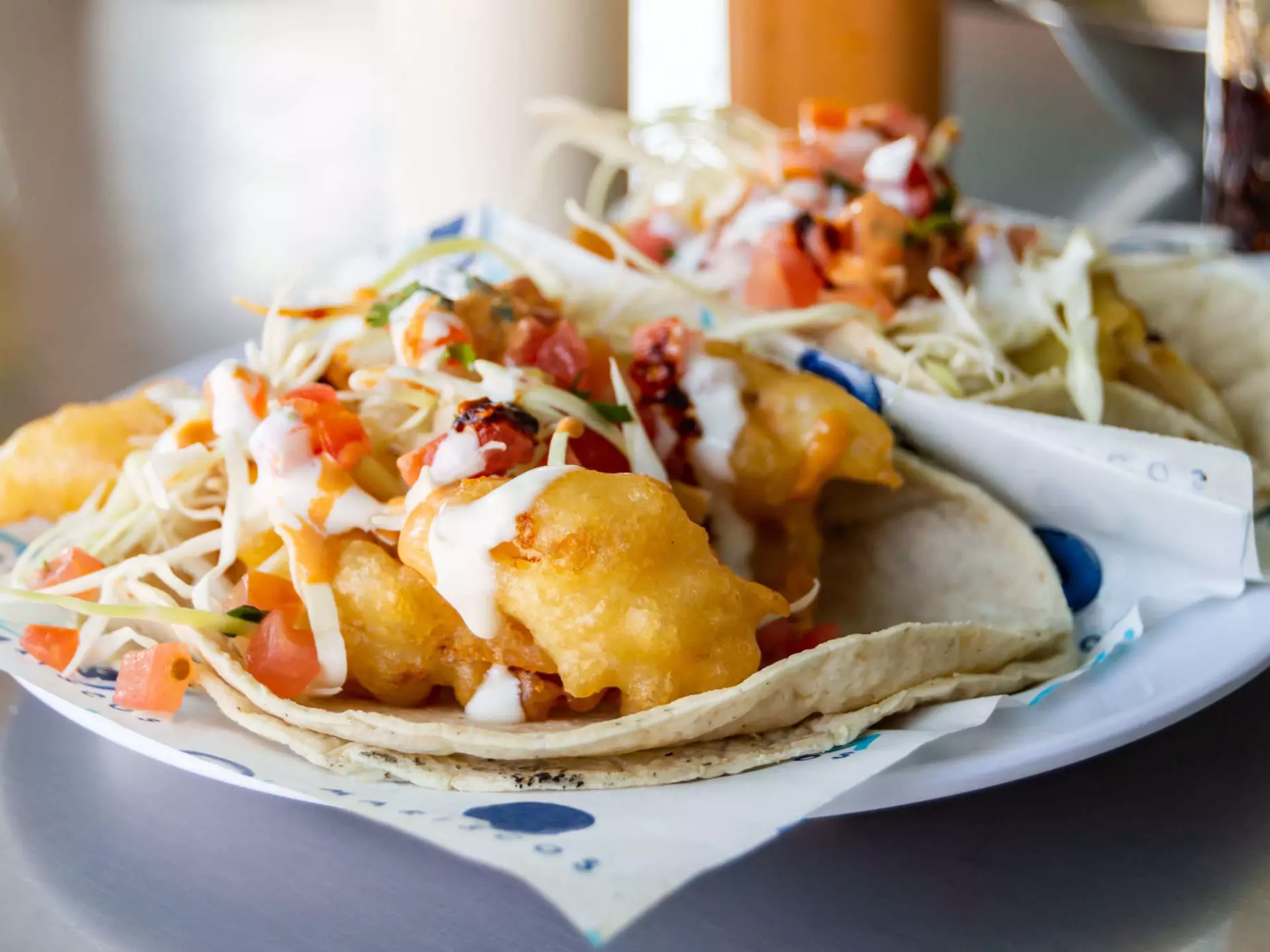 Baja California style fish and shrimp tacos, topped with cabbage, tomatoes, cilantro and a variety of salsas