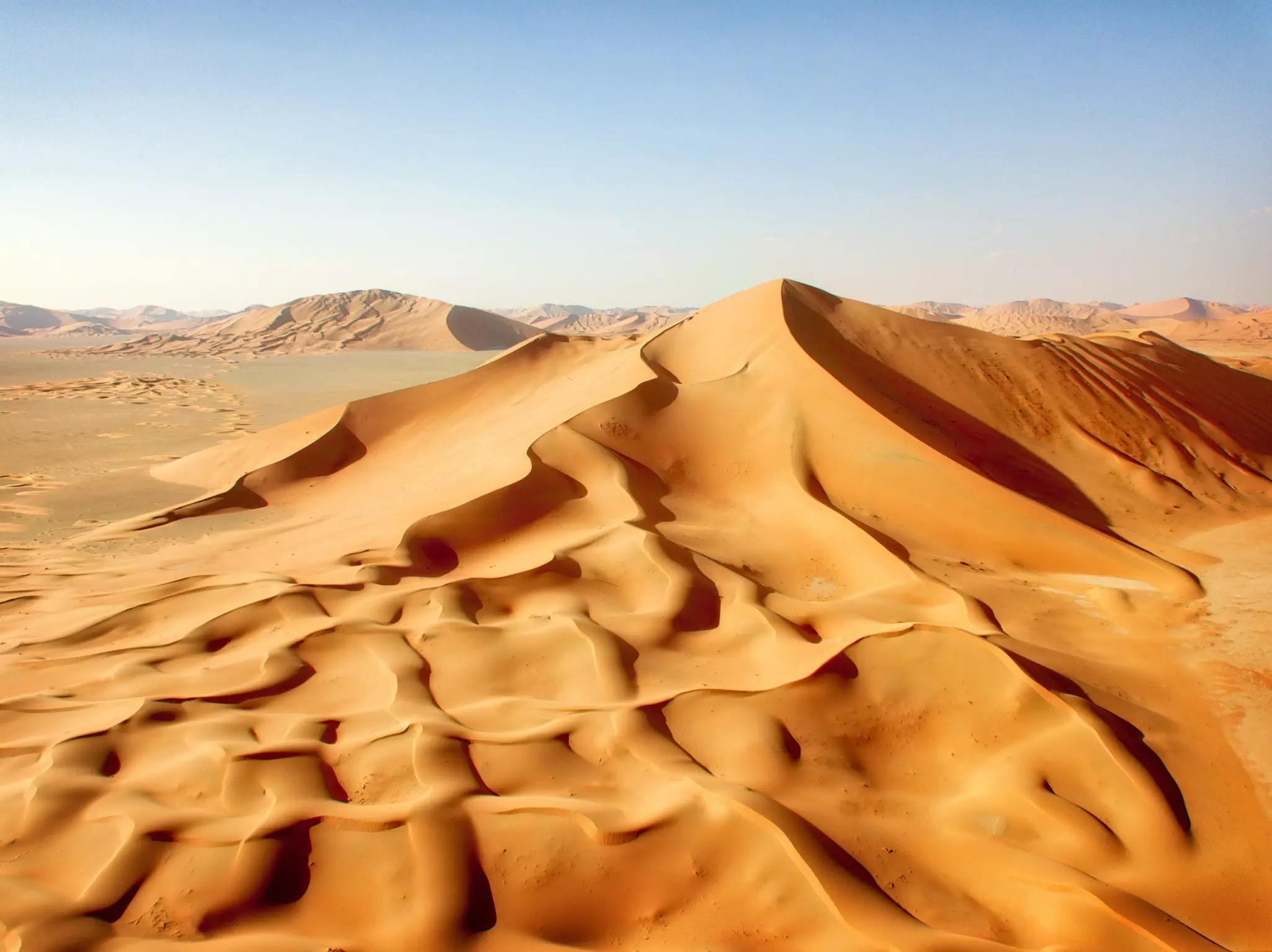 Vast dunes with ripples of golden sand.