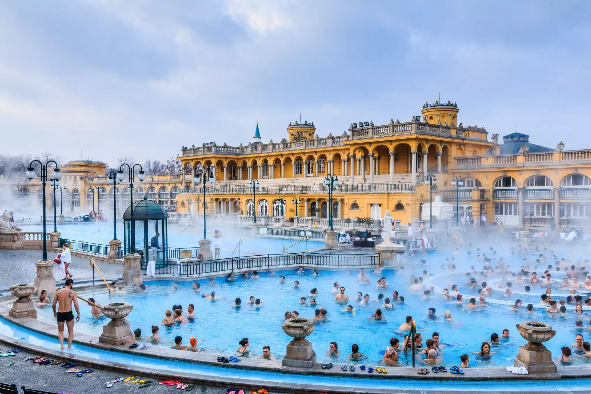 January 1, 2018: Bathers crowd Szechenyi Baths in Budapest.
786688450
architecture, building, europe, tourism, travel, ancient, basin, bath, blue, budapest, city, column, culture, day, east, eastern, european, famous, health, healthcare, hot, hothouse, hungary, interior, landmark, medicinal, old, outdoor, people, pest, photo, pool, public, relax, relaxation, sauna, sculpture, sights, sky, spa, sulfur, swim, szchenyi, szechenyi, thermal, tourist, vacation, water, wellness, winter