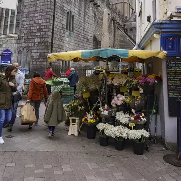 Flower stall Galway Market near The Augustinian Church in Galway, Ireland. Church in background. 