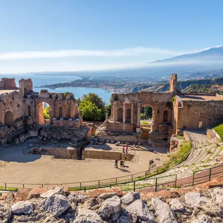 An aerial view of an ancient amphitheater high about the sea in Italy.