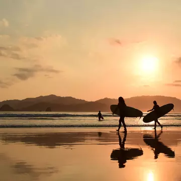 Banyuwangi, Indonesia: Pantai Pulau Merah known for its stunning beauty destination for locals and tourists, offering a serene environment, scenic views, and a variety of activities.