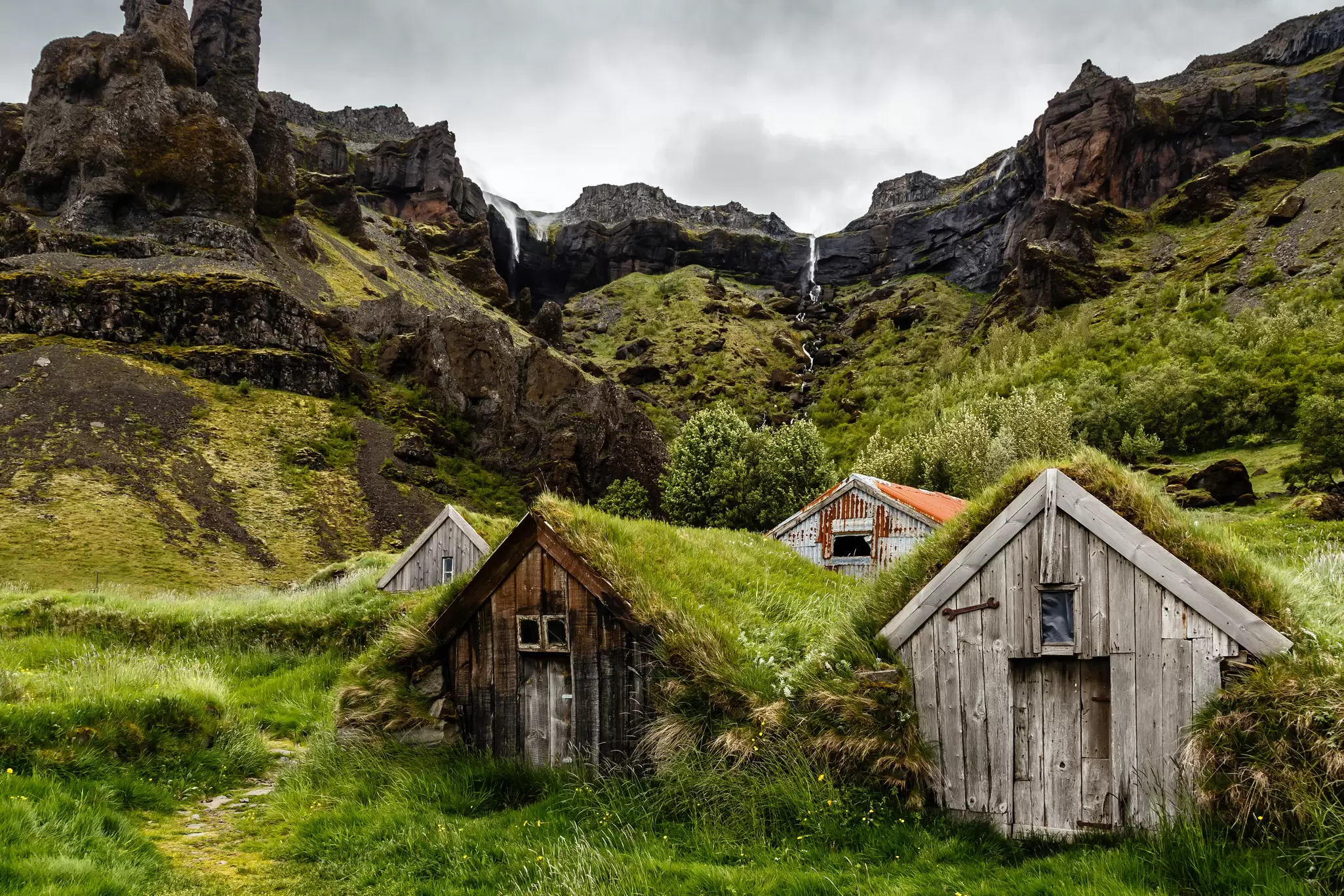 Icelandic turf houses and rocks with waterfall in the background near Kalfafell vilage, Southern Iceland, License Type: media, Download Time: 2025-12-10T17:43:38.000Z, User: sevelynd12, Editorial: false, purchase_order: 56500 - T&R or Kids, job: Global Publishing WIP, client: Dream Trips of Europe, other: Sharon Dortenzio