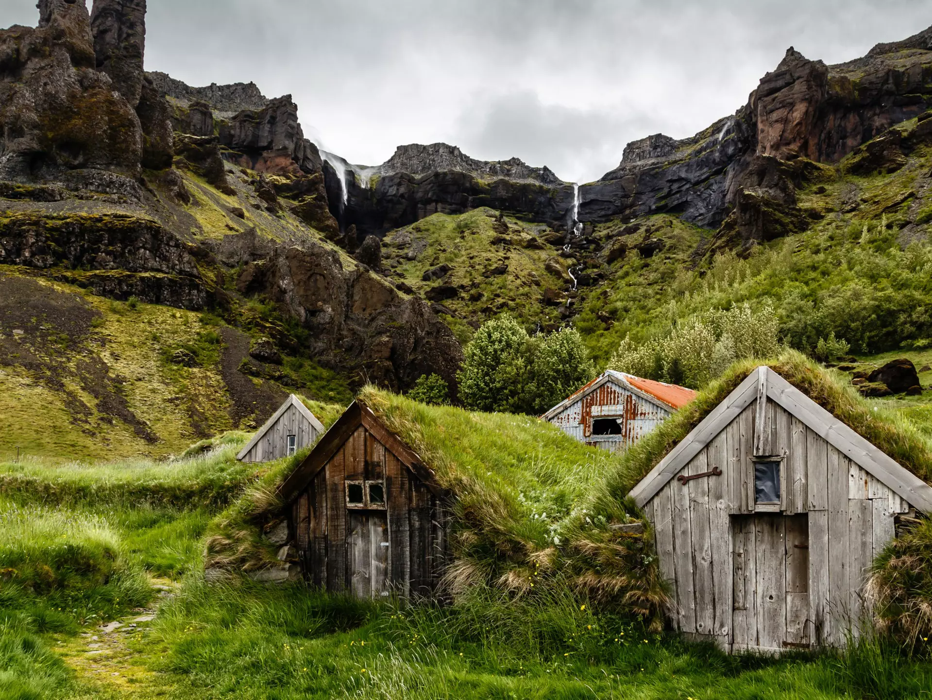 Icelandic turf houses and rocks with waterfall in the background near Kalfafell vilage, Southern Iceland, License Type: media, Download Time: 2025-12-10T17:43:38.000Z, User: sevelynd12, Editorial: false, purchase_order: 56500 - T&R or Kids, job: Global Publishing WIP, client: Dream Trips of Europe, other: Sharon Dortenzio