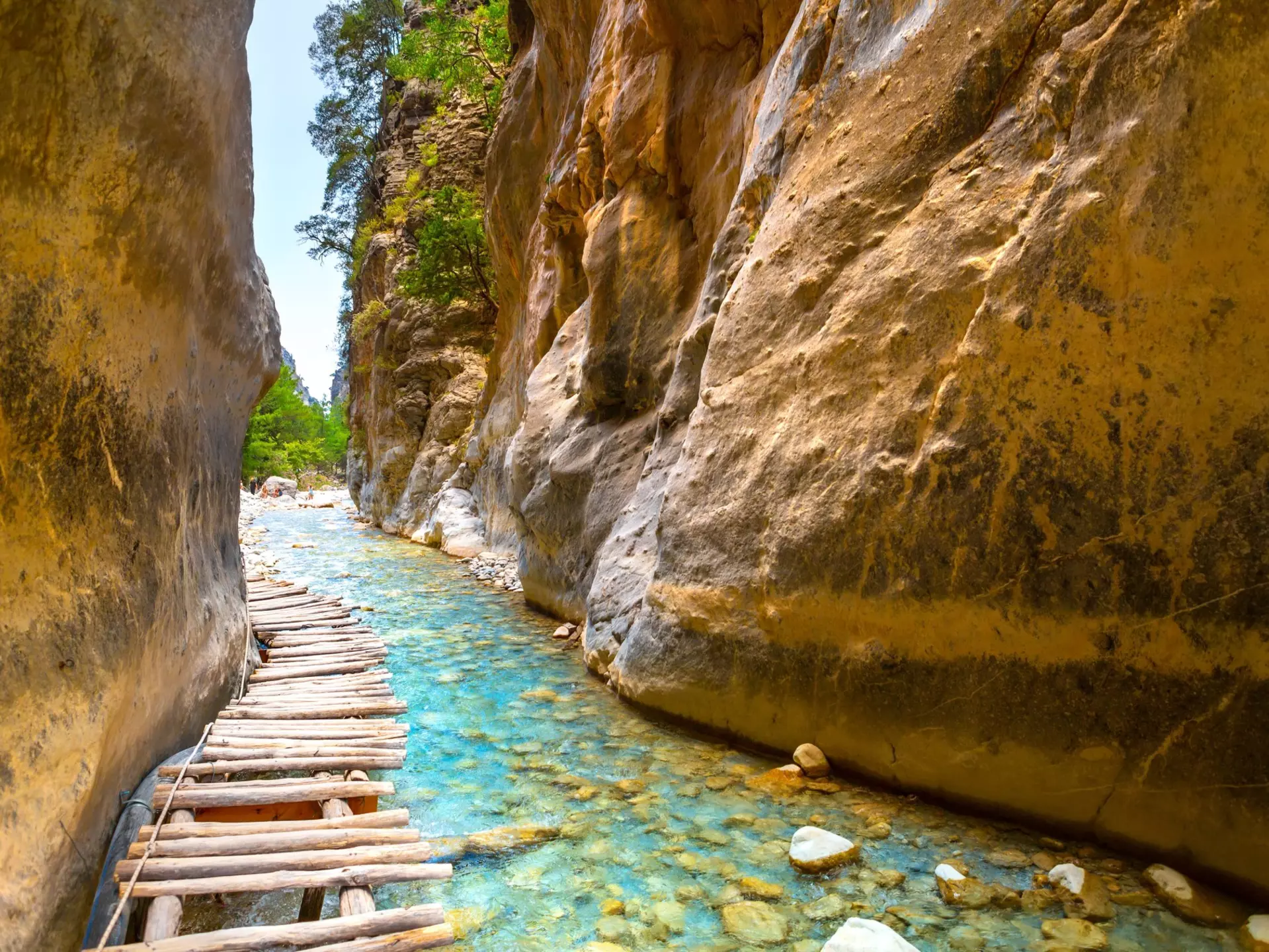 Crossing over these small wooden bridges is one of the most enjoyable stretches of the Samaria Gorge hike. proslgn/Shutterstock