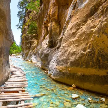 Crossing over these small wooden bridges is one of the most enjoyable stretches of the Samaria Gorge hike. proslgn/Shutterstock