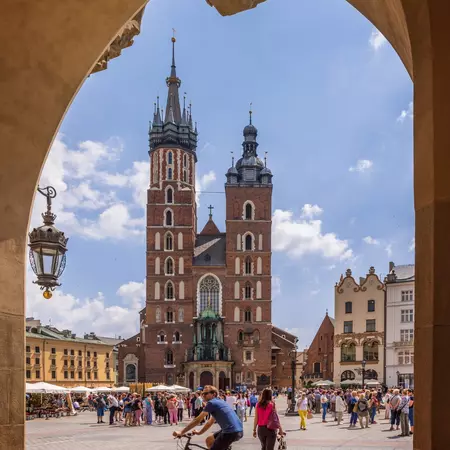 a historic old square with a red building and metal spires