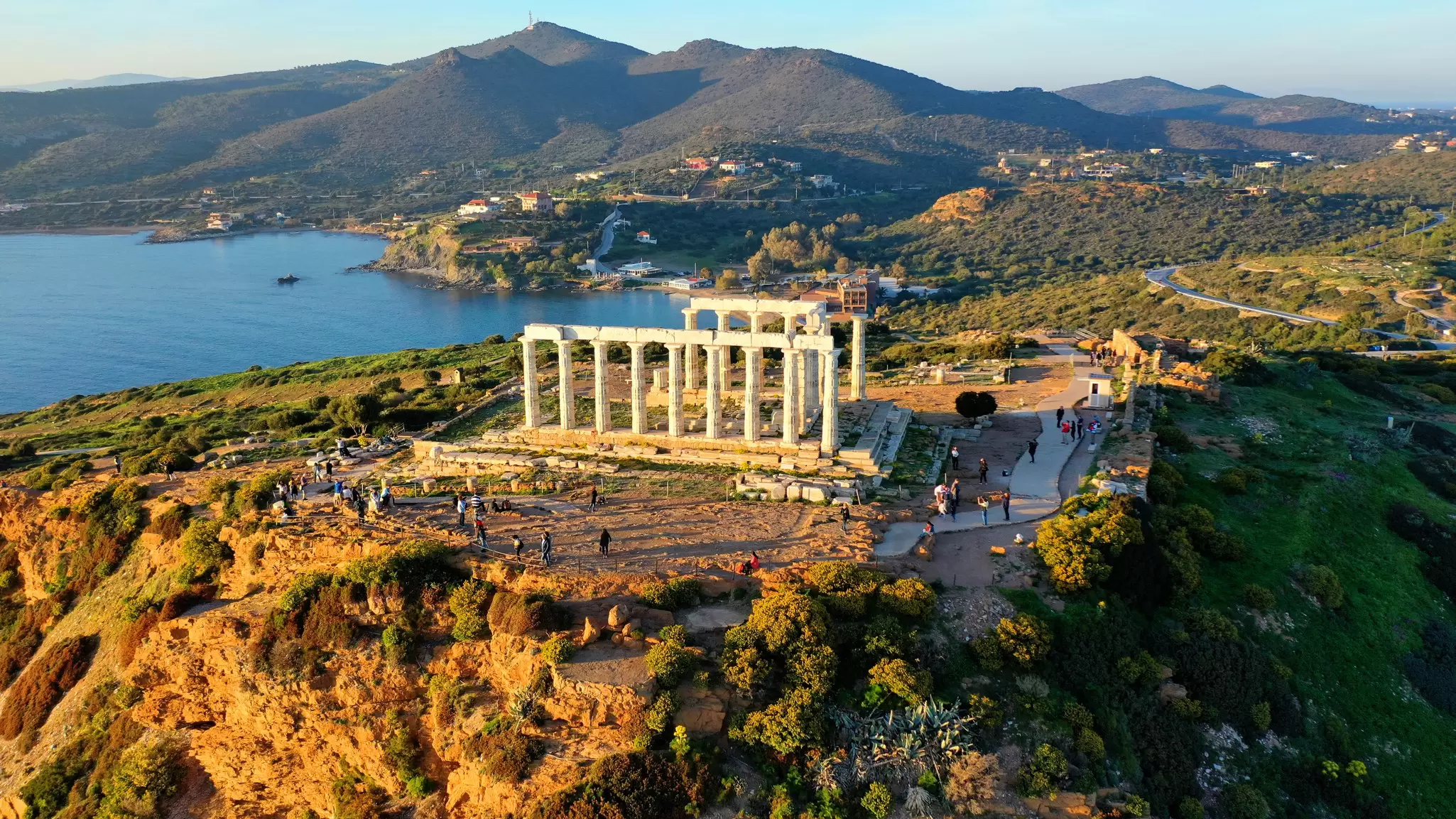 Aerial drone photo of archaeological site of Cape Sounio with iconic ruins of Temple of Poseidon at sunset, Attica, Greece
