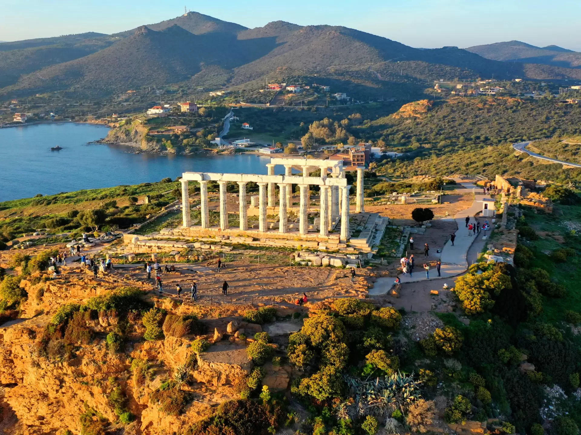 Aerial drone photo of archaeological site of Cape Sounio with iconic ruins of Temple of Poseidon at sunset, Attica, Greece