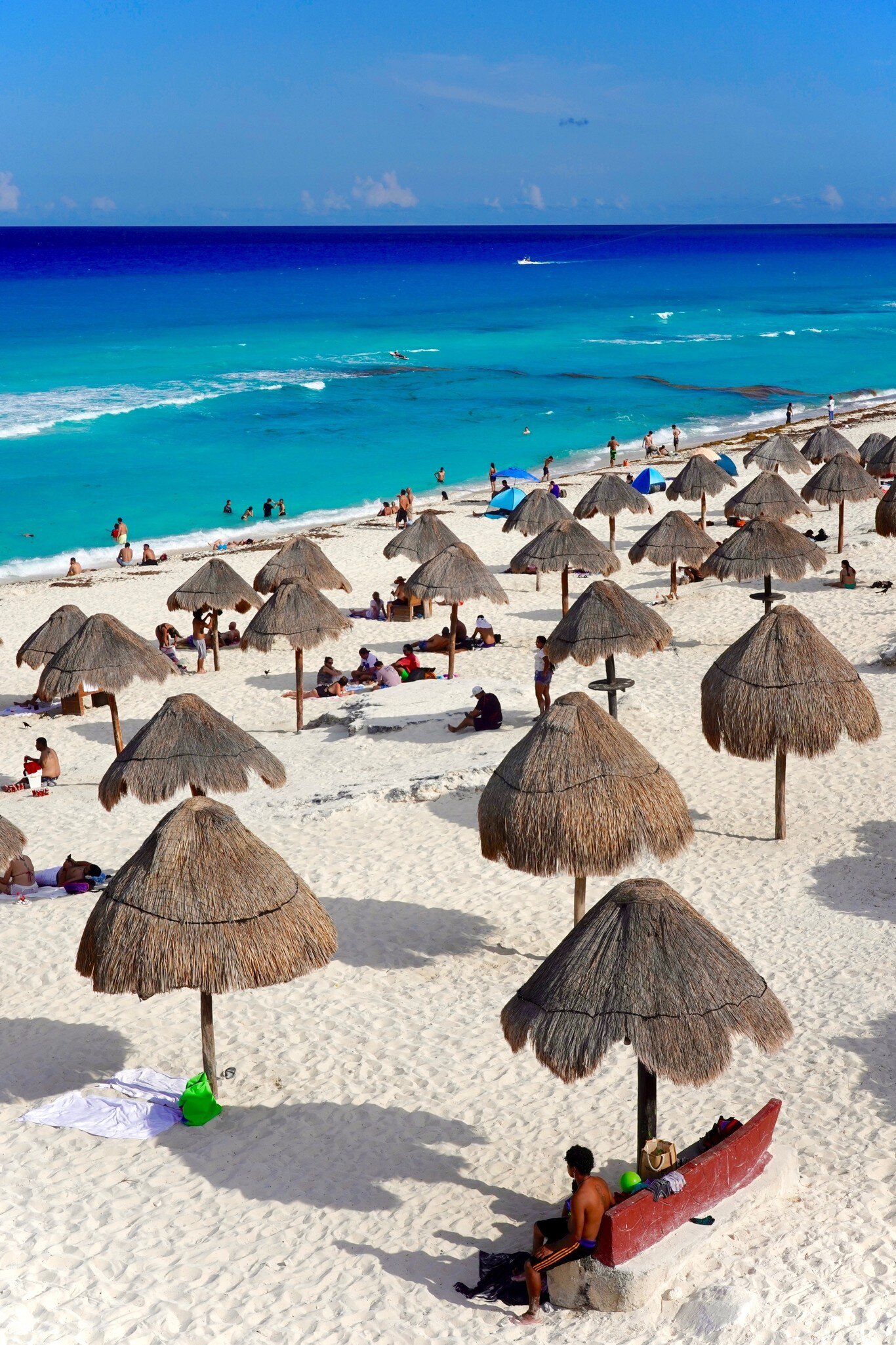 Cancun, Quintana Roo, Mexico - June 3, 2024: The warm turquoise and blue Caribbean waters and white sand of Cancun's Dolphin Beach on the Riviera Maya make it a favorite of locals and tourists., License Type: media, Download Time: 2025-05-22T14:22:42.000Z, User: lonelyplanetmedia, Editorial: true, purchase_order: 65050 - Digital Destinations and Articles, job: Global Publishing WIP, client: Global Publishing WIP, other: Pia Peterson Haggarty // SS Comp Ingestion