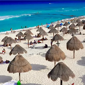 Cancun, Quintana Roo, Mexico - June 3, 2024: The warm turquoise and blue Caribbean waters and white sand of Cancun's Dolphin Beach on the Riviera Maya make it a favorite of locals and tourists., License Type: media, Download Time: 2025-05-22T14:22:42.000Z, User: lonelyplanetmedia, Editorial: true, purchase_order: 65050 - Digital Destinations and Articles, job: Global Publishing WIP, client: Global Publishing WIP, other: Pia Peterson Haggarty // SS Comp Ingestion