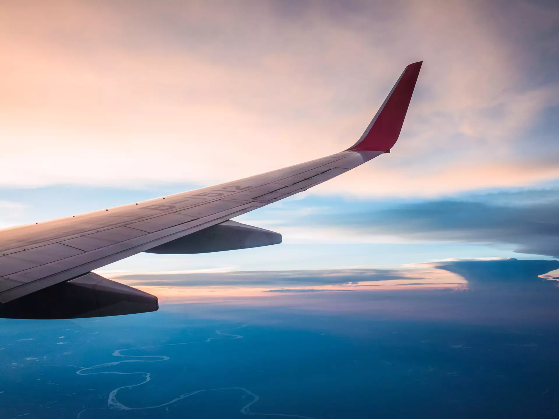 Wing of plane flying over land