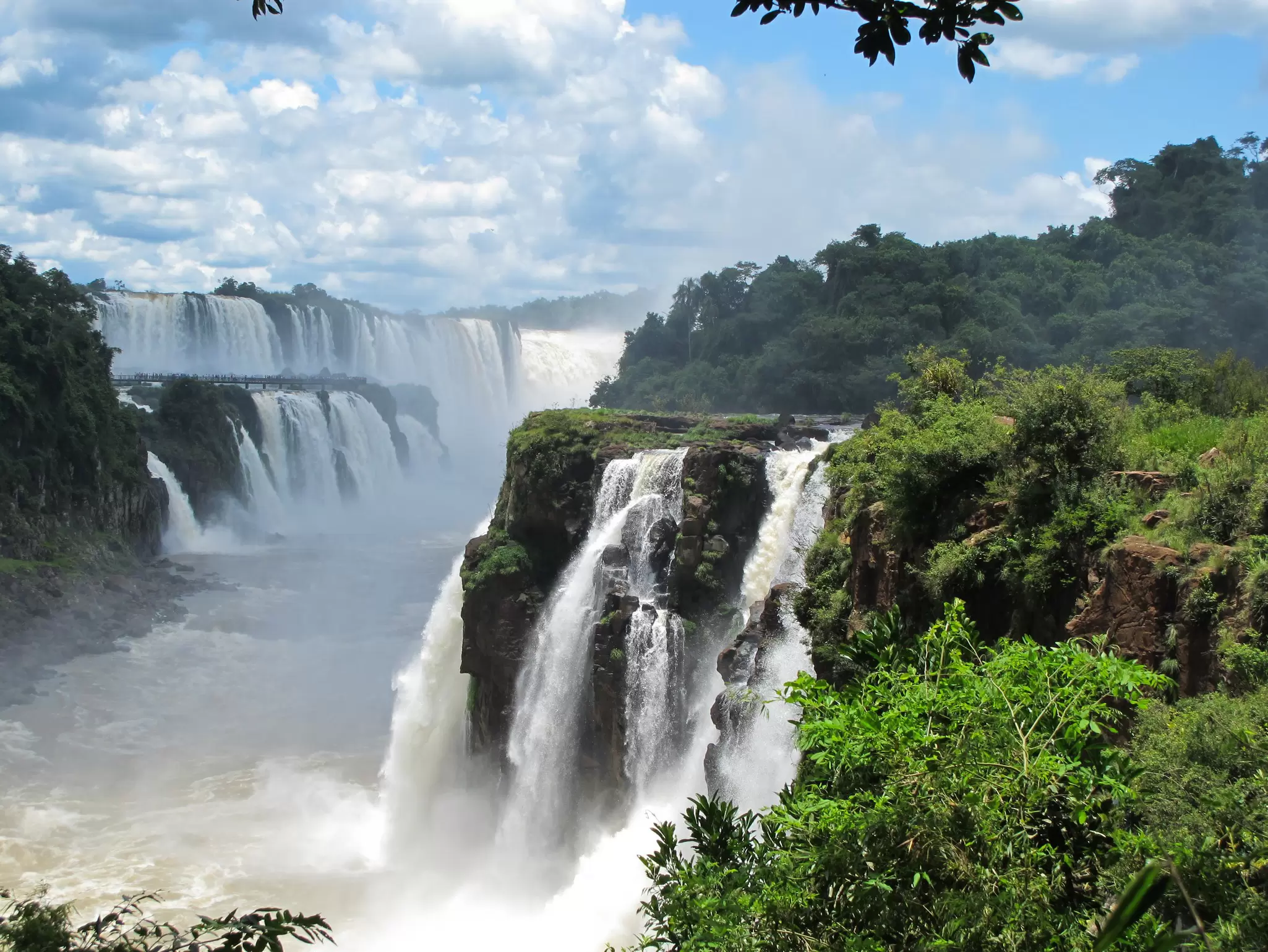 View of Iguazú Falls taken on the Argentinian side of the falls on a sunny day.