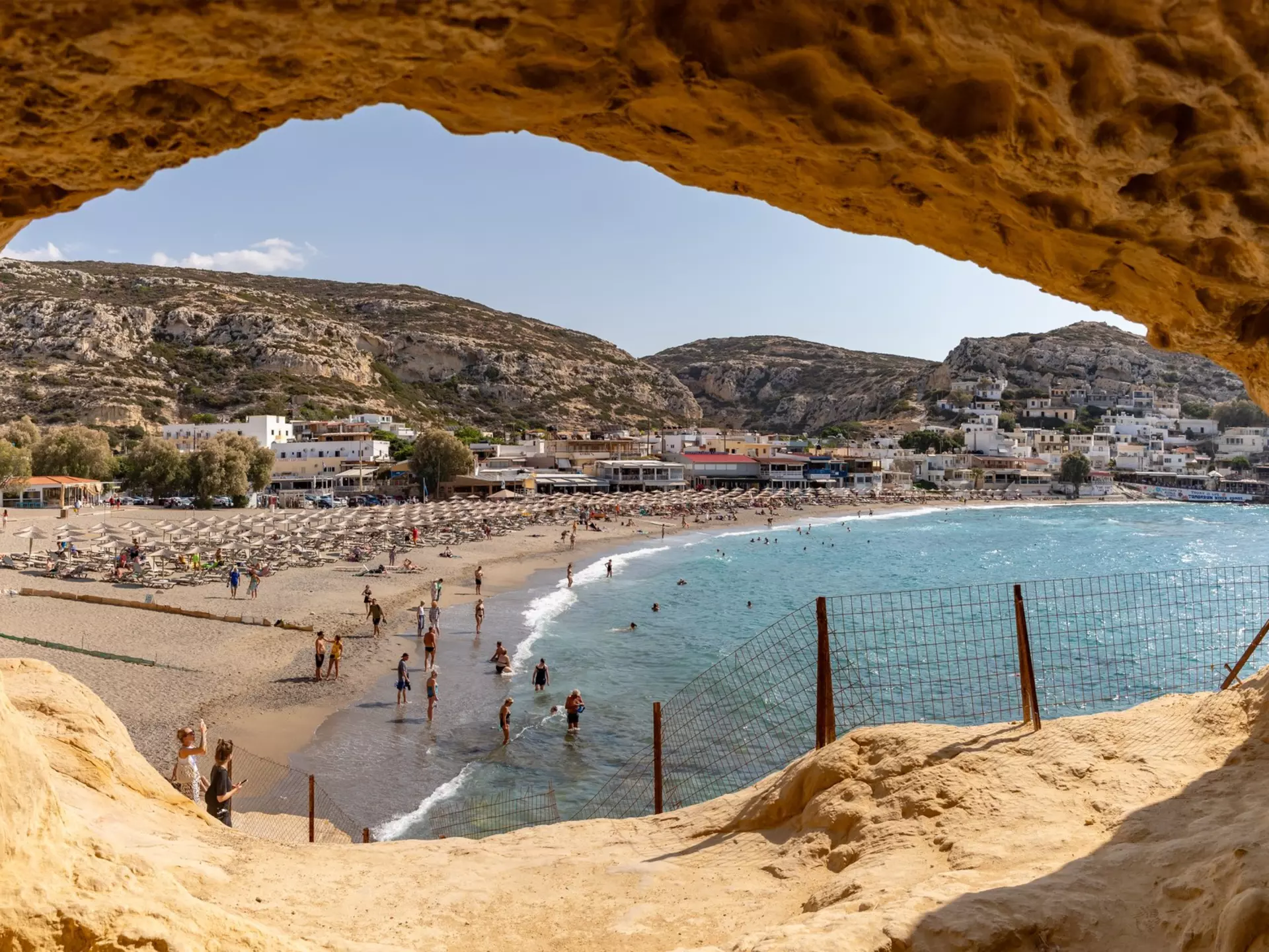 A picture of Matala Beach as seen from inside one of its caves, Crete, Greece