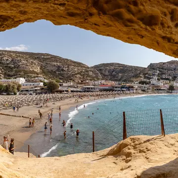A picture of Matala Beach as seen from inside one of its caves, Crete, Greece