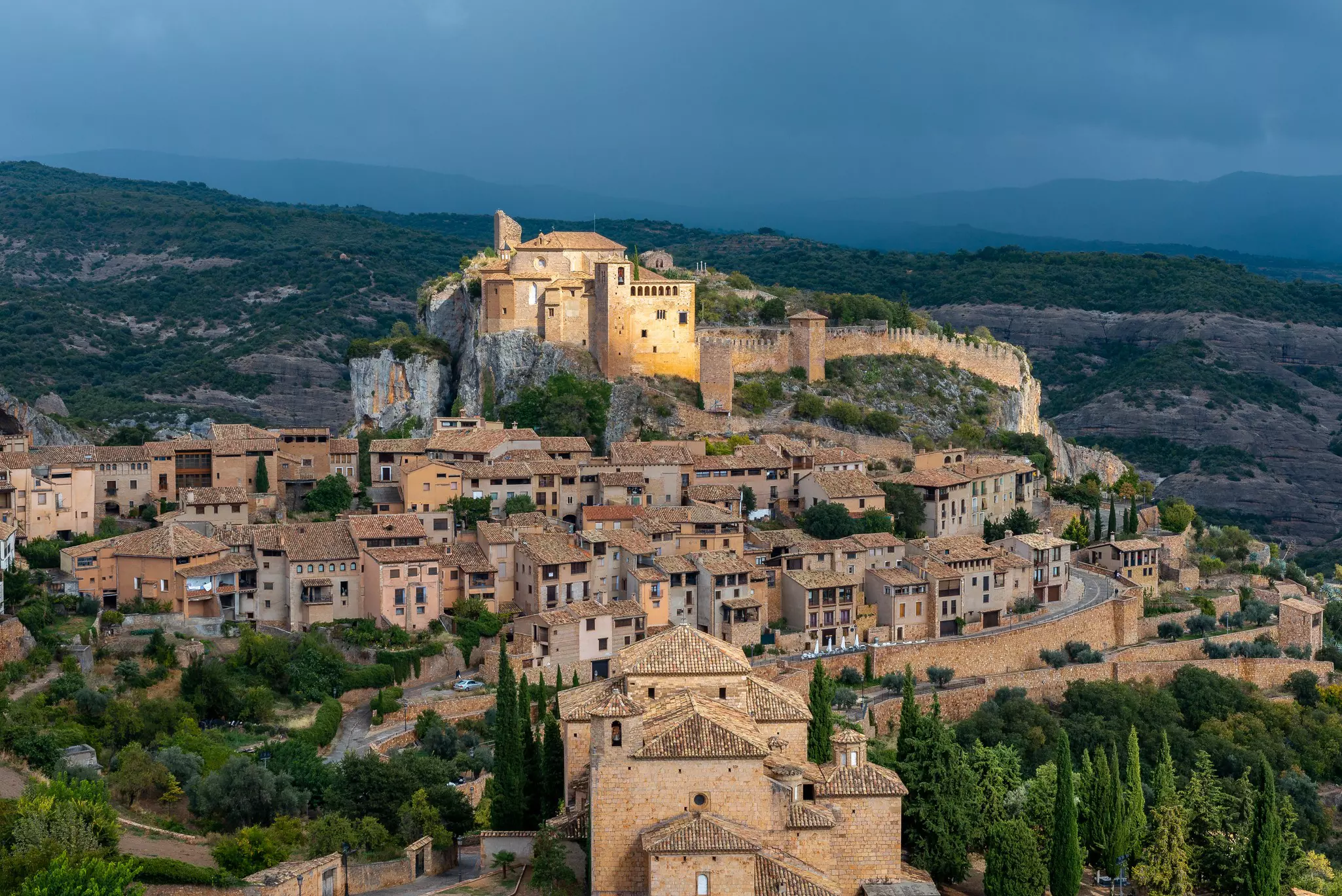 The medieval houses of Alquézar in Aragon, Spain, illuminated by a shaft of light.
