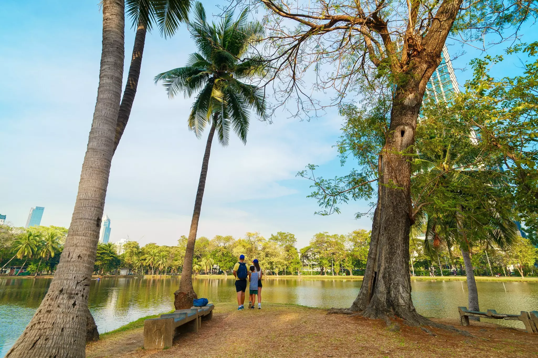 Family of three at Lumphini Park in a peaceful nature setting