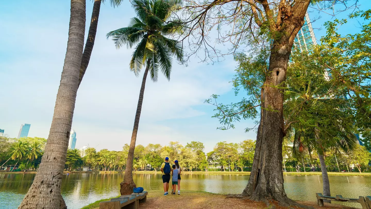 Family of three at Lumphini Park in a peaceful nature setting