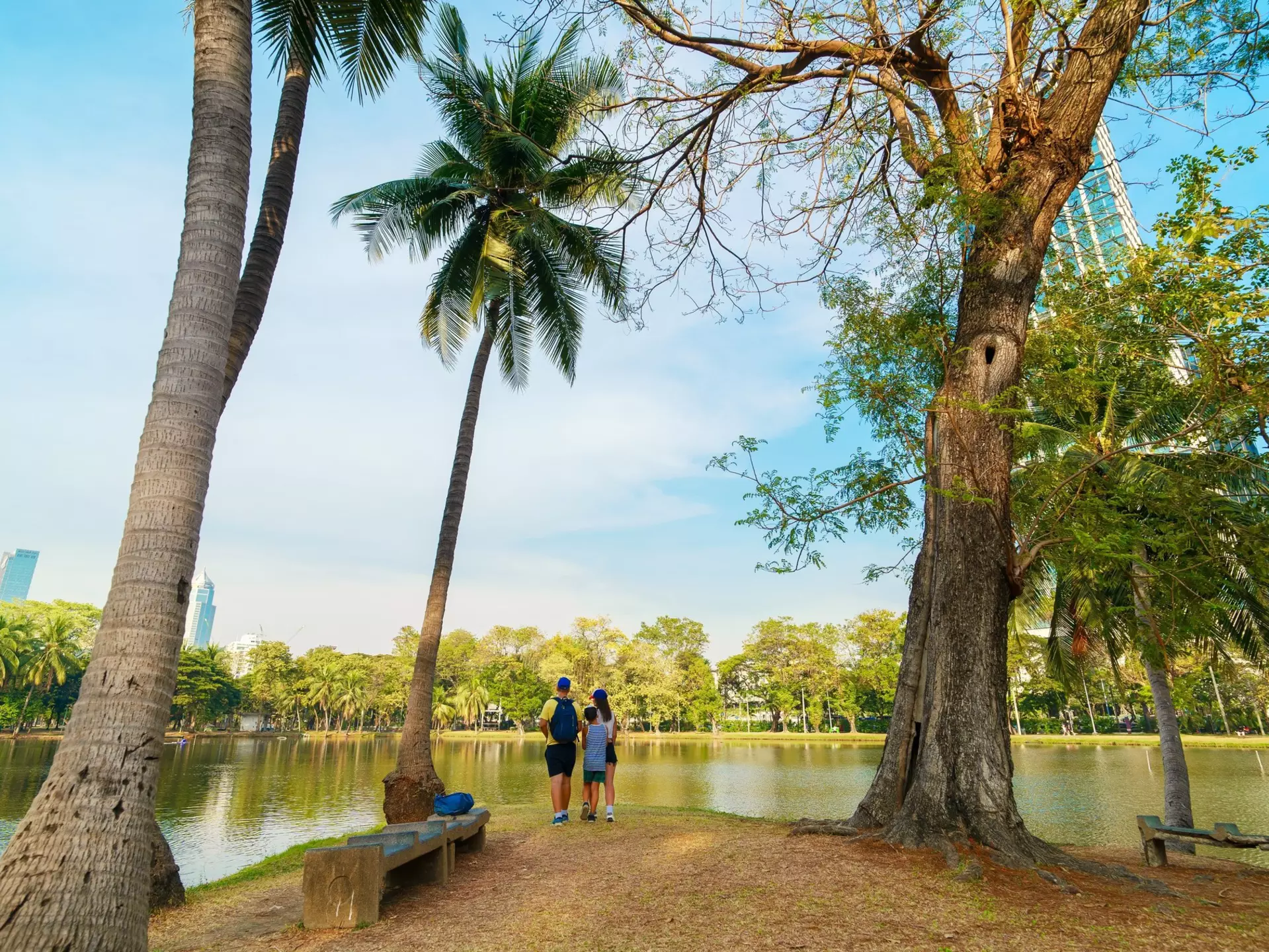 Family of three at Lumphini Park in a peaceful nature setting