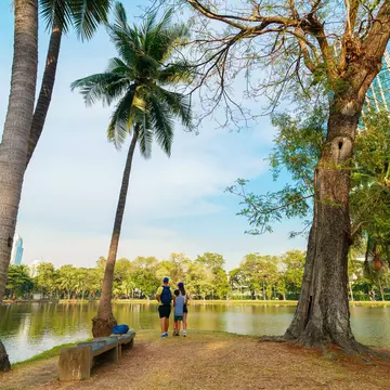 Family of three at Lumphini Park in a peaceful nature setting