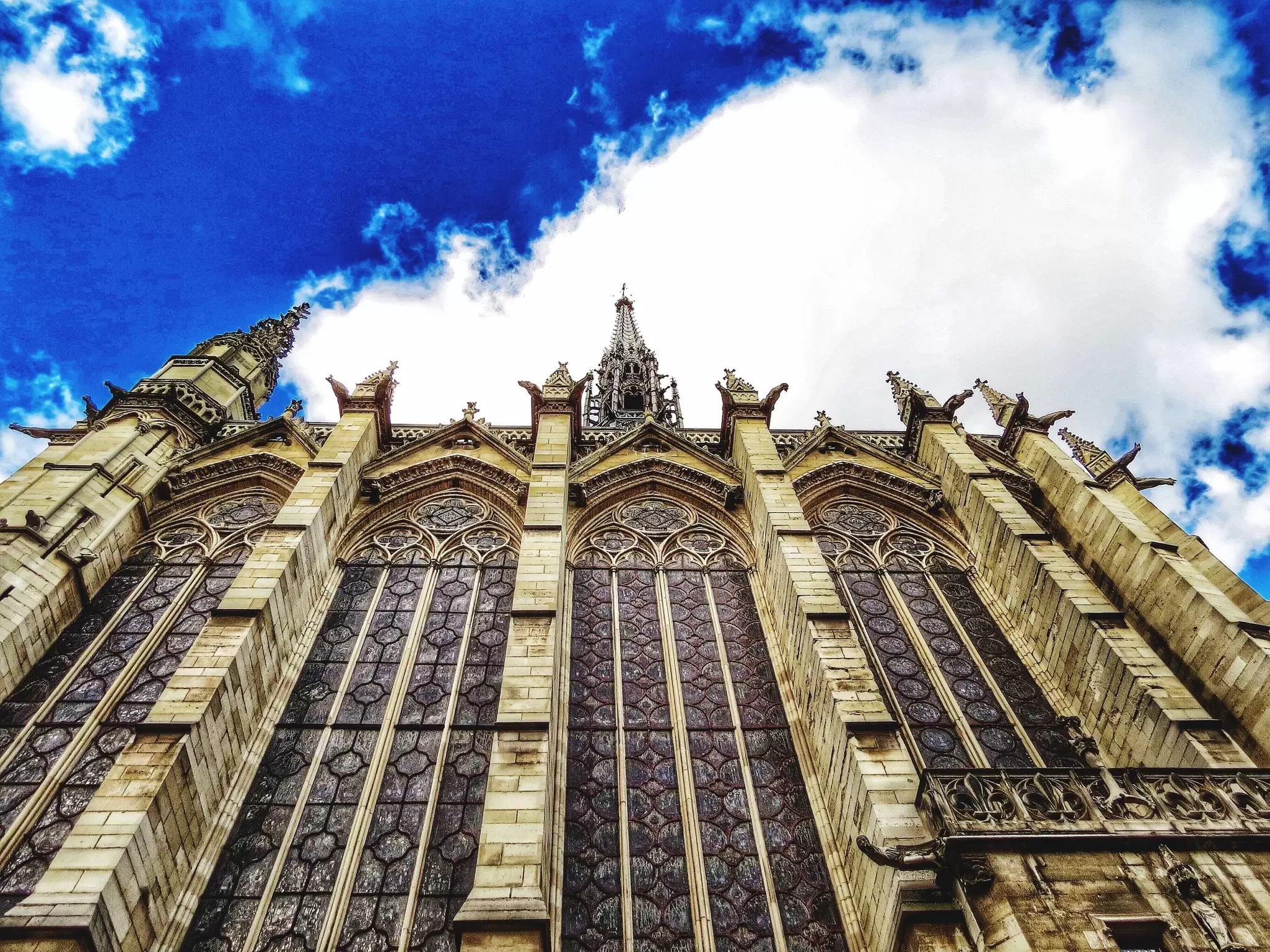 Low Angle View Of Sainte-Chapelle Against Cloudy Sky