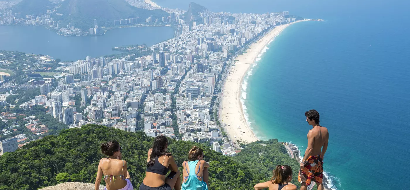 RIO DE JANEIRO - MARCH 9, 2016: Visitors take in the view of the city skyline after a hike to the top of Dois Irmaos (Two Brothers) Mountain, overlooking Ipanema Beach. , License Type: media, Download Time: 2025-05-22T13:23:19.000Z, User: lonelyplanetmedia, Editorial: true, purchase_order: 65050 - Digital Destinations and Articles, job: Global Publishing WIP, client: Global Publishing WIP, other: Pia Peterson Haggarty // SS Comp Ingestion