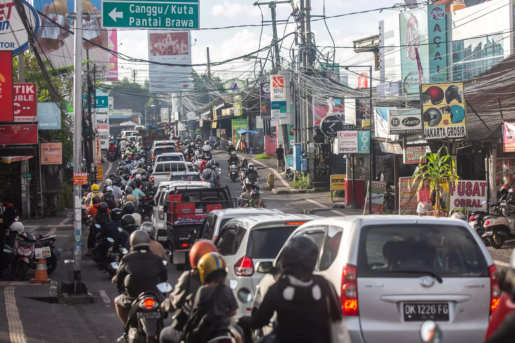 Cars and motorcycles stuck in traffic queues in Canggu, Bali, Indonesia.