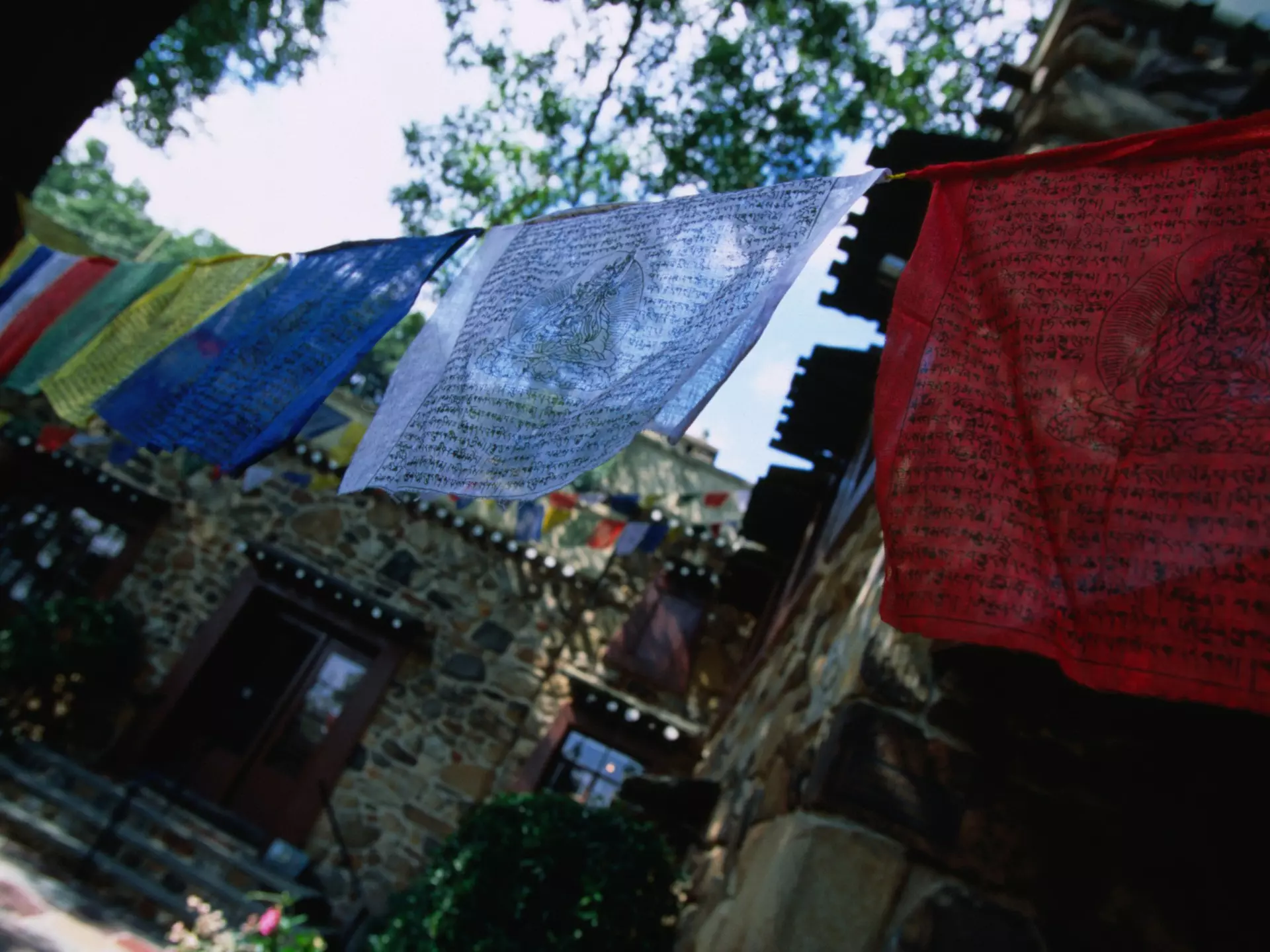 Colorful prayer flags hanging at the Jacques Marchais Centre of Tibetan Art, which houses the largest collection of Tibetan art outside China © Angus Oborn / Lonely Planet