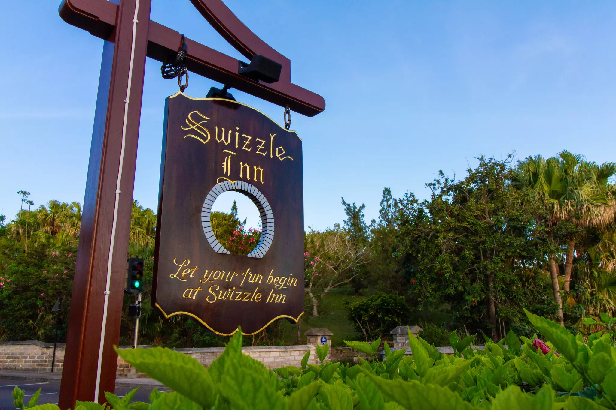 A wood sign reads "Swizzle Inn"