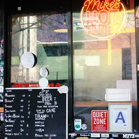 Exterior window of L'Industrie, a pizza restaurant in Williamsburg, Brooklyn
