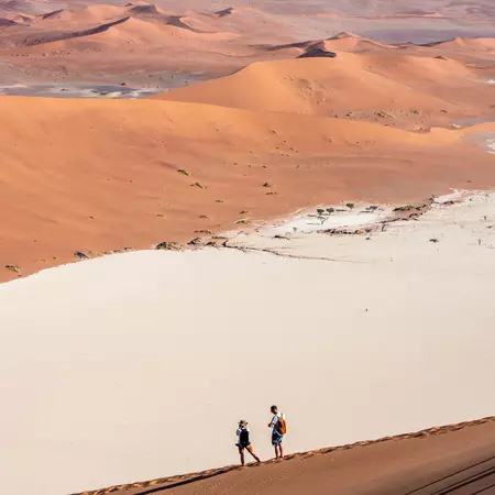 Two people overlooking a dune in Namibia