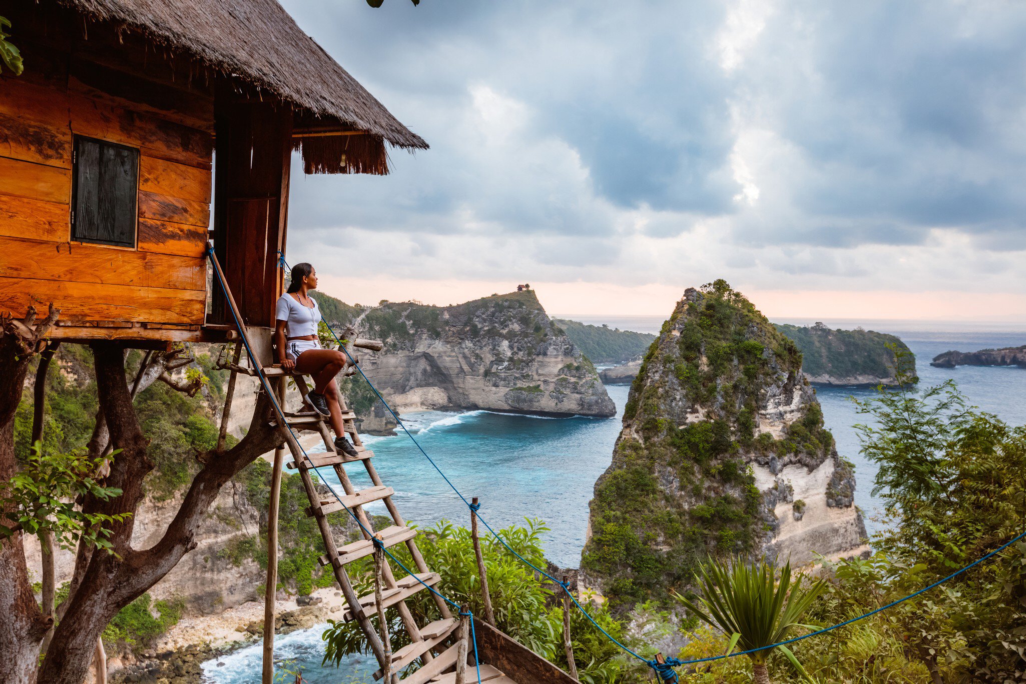 Woman near tree house, Nusa Penida, Bali, Indonesia
