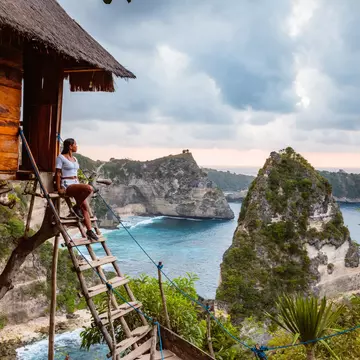 Woman near tree house, Nusa Penida, Bali, Indonesia