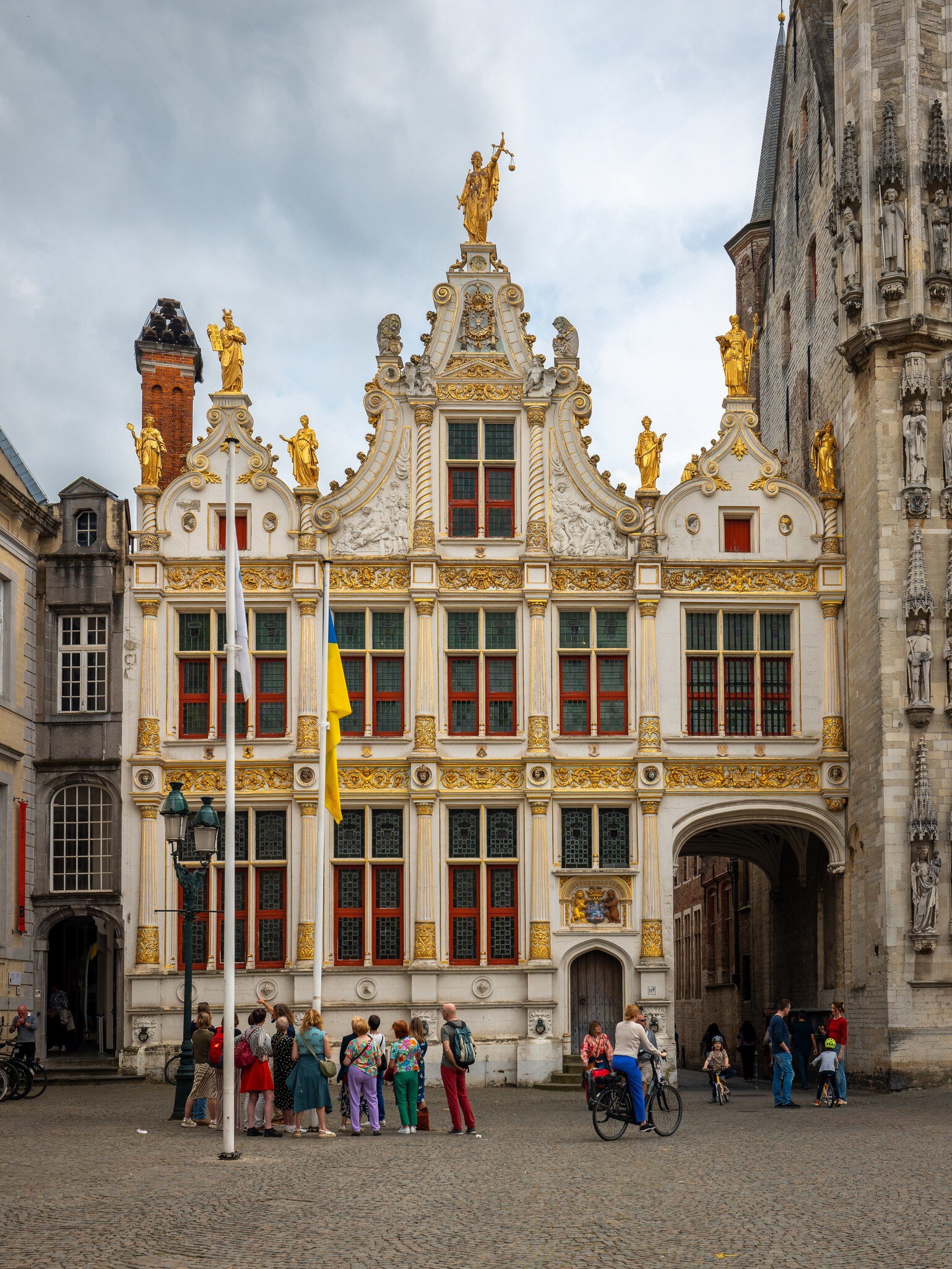 Bruges, Belgium - May 14, 2024: Tourists looking at the facade of the Brugse Vrije (Liberty of Bruges), License Type: media, Download Time: 2026-04-24T14:31:45.000Z, User: LP_NZhan, Editorial: true, purchase_order: 65050 - Digital Destinations and Articles, job: App content, client: Lonely Planet App, other: Nadine Zhan