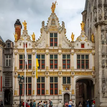 Bruges, Belgium - May 14, 2024: Tourists looking at the facade of the Brugse Vrije (Liberty of Bruges), License Type: media, Download Time: 2026-04-24T14:31:45.000Z, User: LP_NZhan, Editorial: true, purchase_order: 65050 - Digital Destinations and Articles, job: App content, client: Lonely Planet App, other: Nadine Zhan