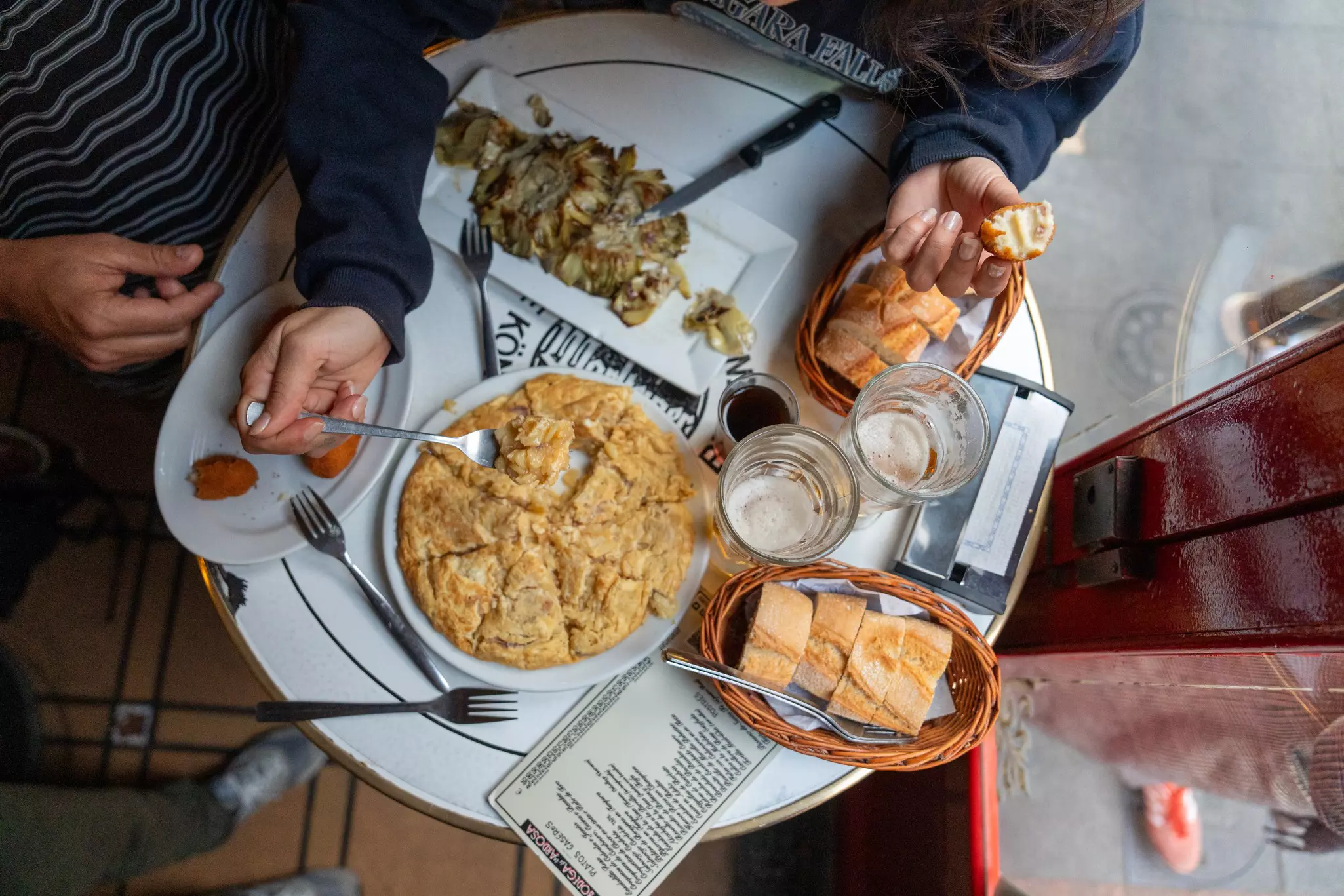 An overhead view of plates of tapas and beer in Madrid, Spain