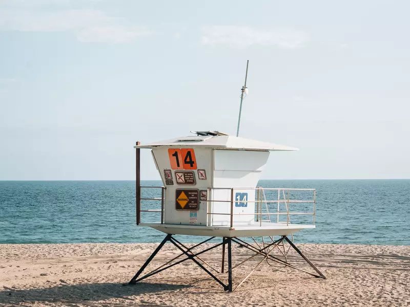 A wooden hut on stilts on a sandy beach