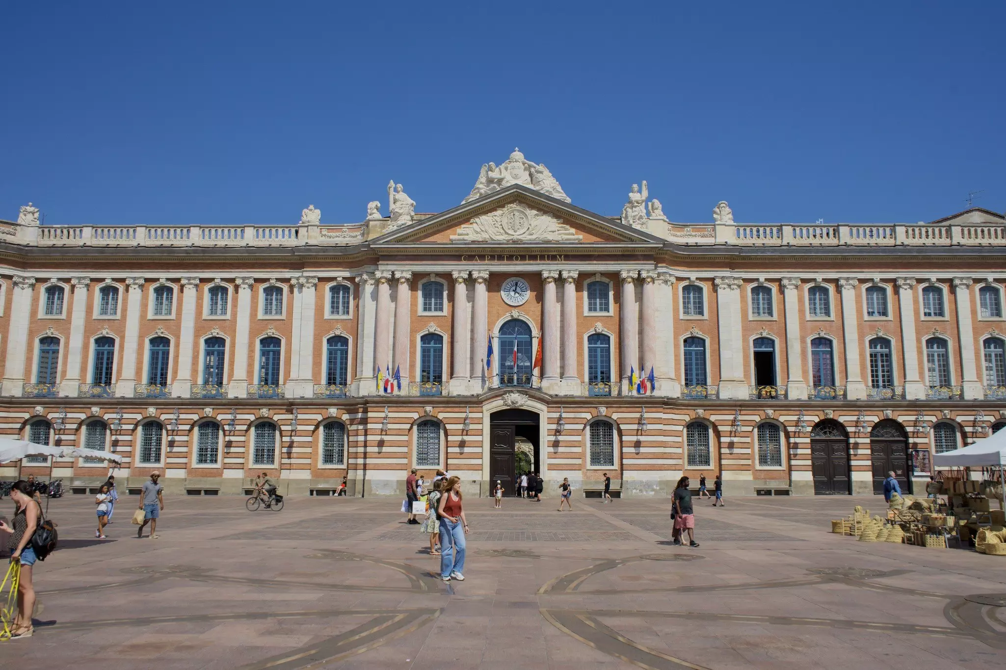 People walking outside the Place du Capitole, Toulouse, France.