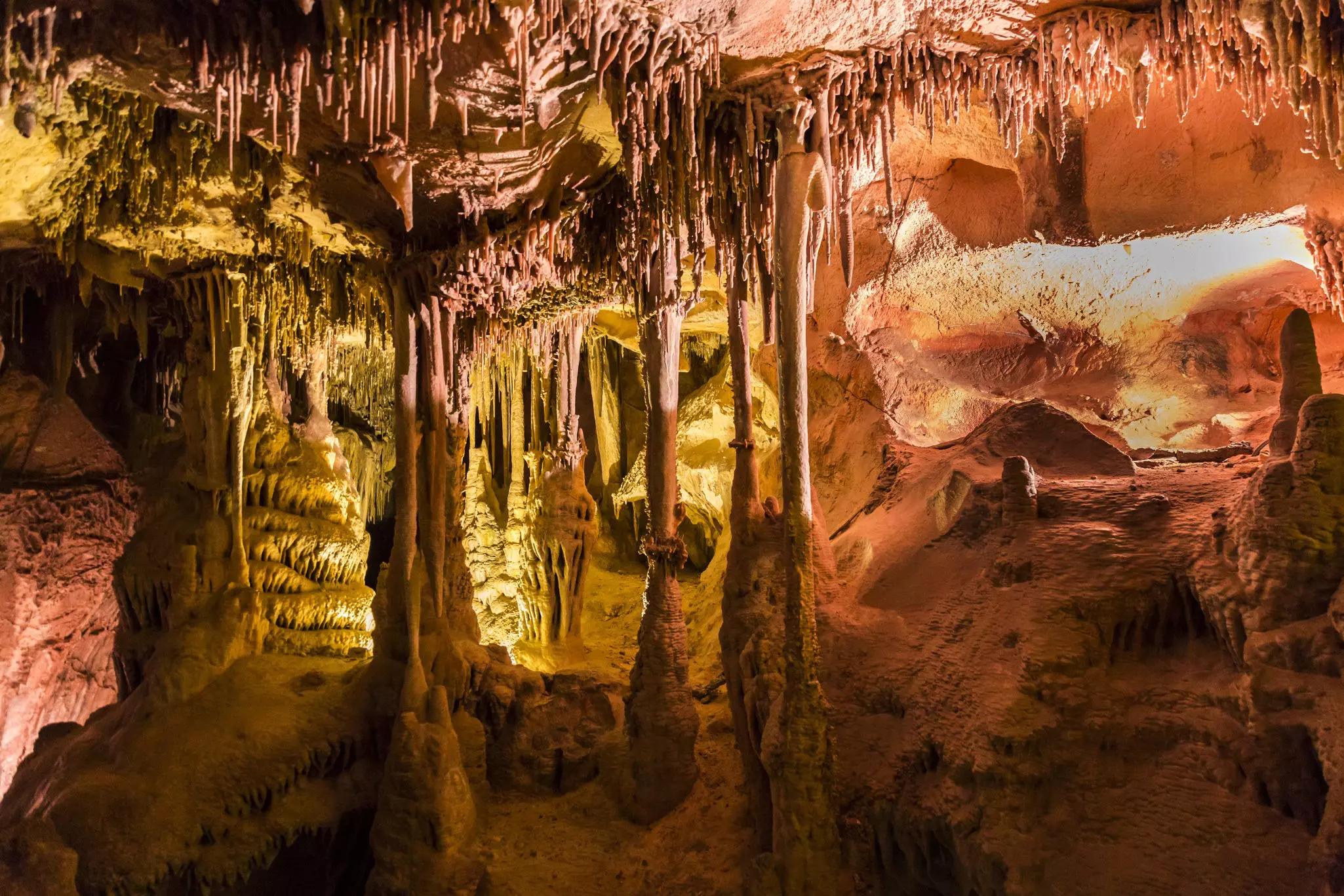 A cave with natural rock formations including delicate stalagmites and stalactites.