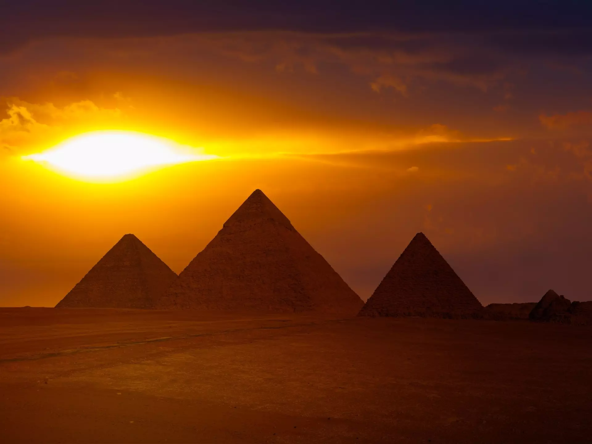 Wide view of the Giza Pyramid Complex at sunset near Cairo, Egypt