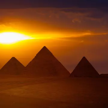Wide view of the Giza Pyramid Complex at sunset near Cairo, Egypt
