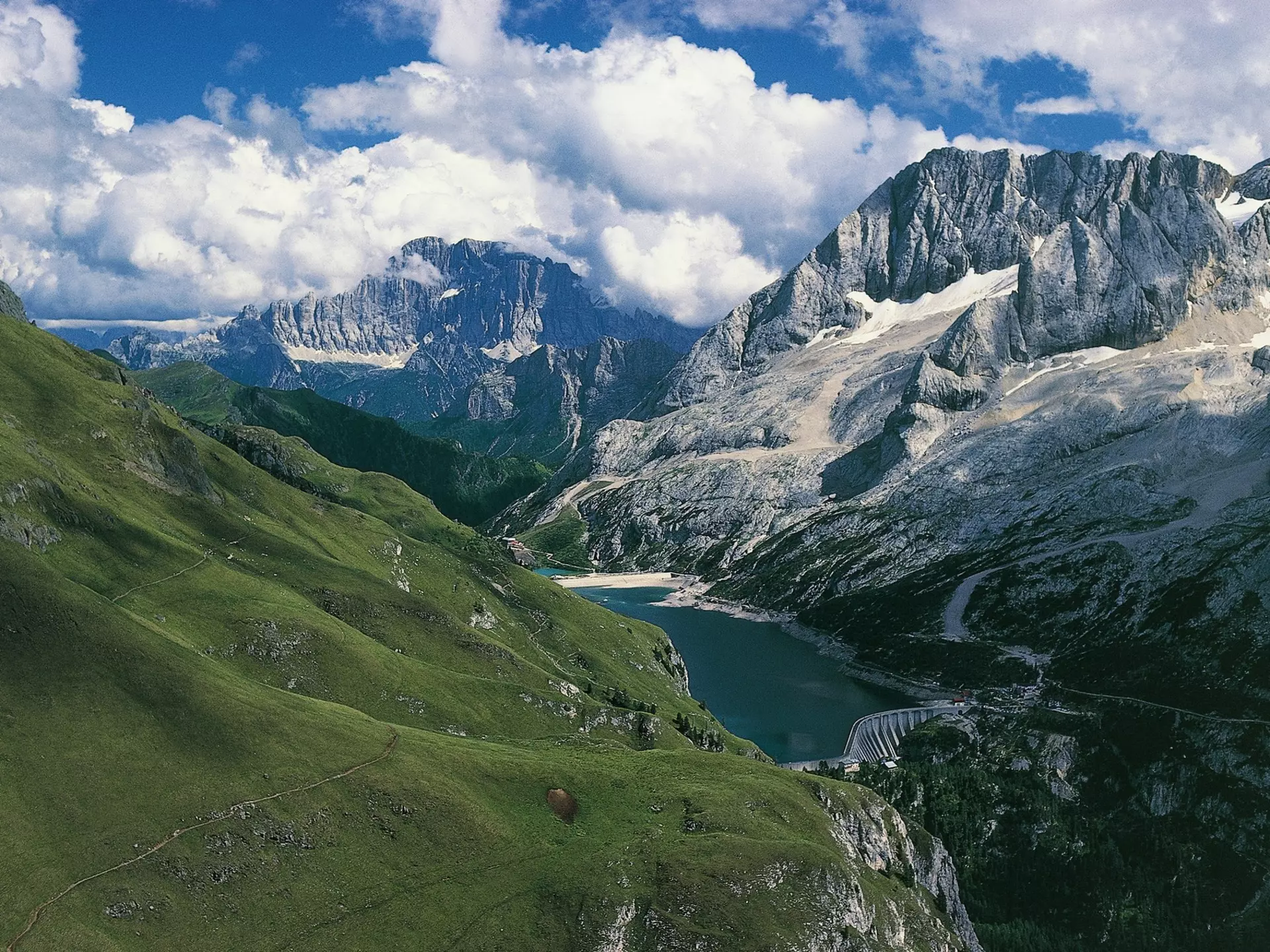 ITALY - MAY 05:  Marmolada (3342 metres) and Lake Fedaia, Mount Civetta in the background, Dolomites (UNESCO World Heritage List, 2009), Trentino-Alto Adige, Veneto, Italy. (Photo by DeAgostini/Getty Images)
167394090
beauty in nature, built structure, dam, day, dolomites, elevated view, extreme terrain, fuel and power generation, horizontal, italy, lake, lake fedaia, landscape, majestic, mountain, mountain range, mt marmolada, no people, non urban scene, outdoors, physical geography, puffy cloud, scenics, sky, snowcapped, sunlight, tranquil scene, tranquility, travel destinations, trentino-alto adige, unesco world heritage site, valley, veneto