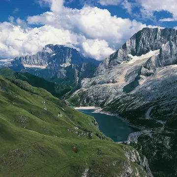 ITALY - MAY 05:  Marmolada (3342 metres) and Lake Fedaia, Mount Civetta in the background, Dolomites (UNESCO World Heritage List, 2009), Trentino-Alto Adige, Veneto, Italy. (Photo by DeAgostini/Getty Images)
167394090
beauty in nature, built structure, dam, day, dolomites, elevated view, extreme terrain, fuel and power generation, horizontal, italy, lake, lake fedaia, landscape, majestic, mountain, mountain range, mt marmolada, no people, non urban scene, outdoors, physical geography, puffy cloud, scenics, sky, snowcapped, sunlight, tranquil scene, tranquility, travel destinations, trentino-alto adige, unesco world heritage site, valley, veneto