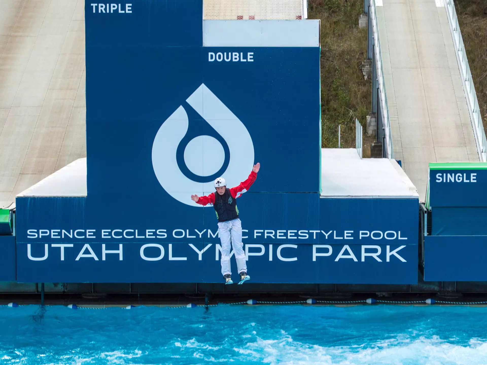 A freestyle skier about to land in a pool after a practice run down a ski ramp at Utah Olympic Park