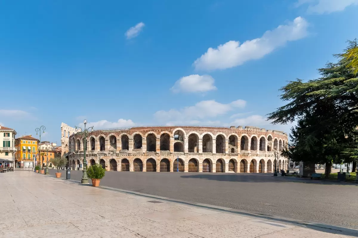 An open square surrounds the vast Arena di Verona amphitheater in Verona, Veneto, Italy. 