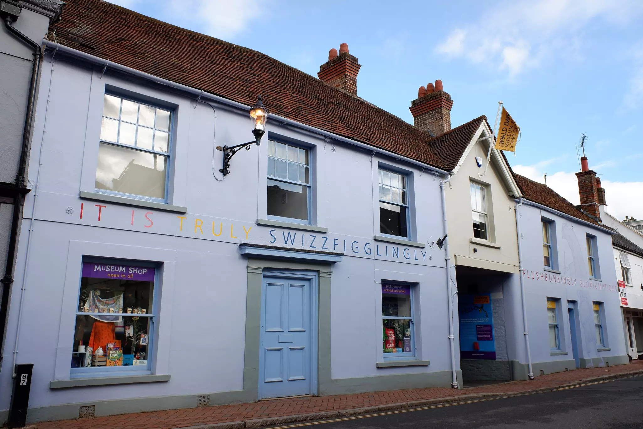 A white-painted building in a historic country village is painted with whimsical words, Great Missenden, Buckinghamshire, England