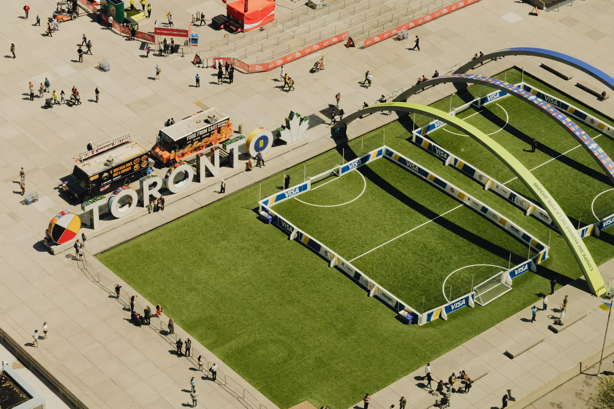 A field with soccer goals set up in front of a large Toronto sign.